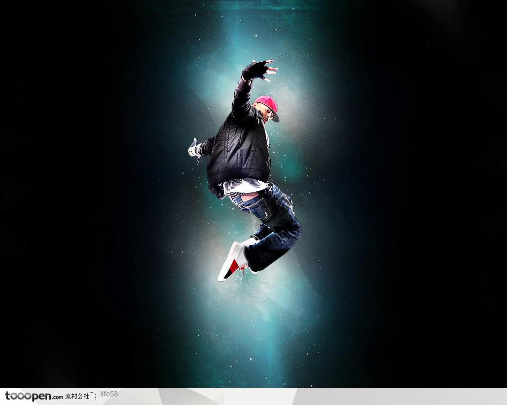 黑暗光芒照射下的带红色帽子的运动男孩跳街舞精品分层素材