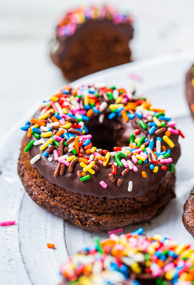 baked chocolate donuts with chocolate ganache and sprinkles