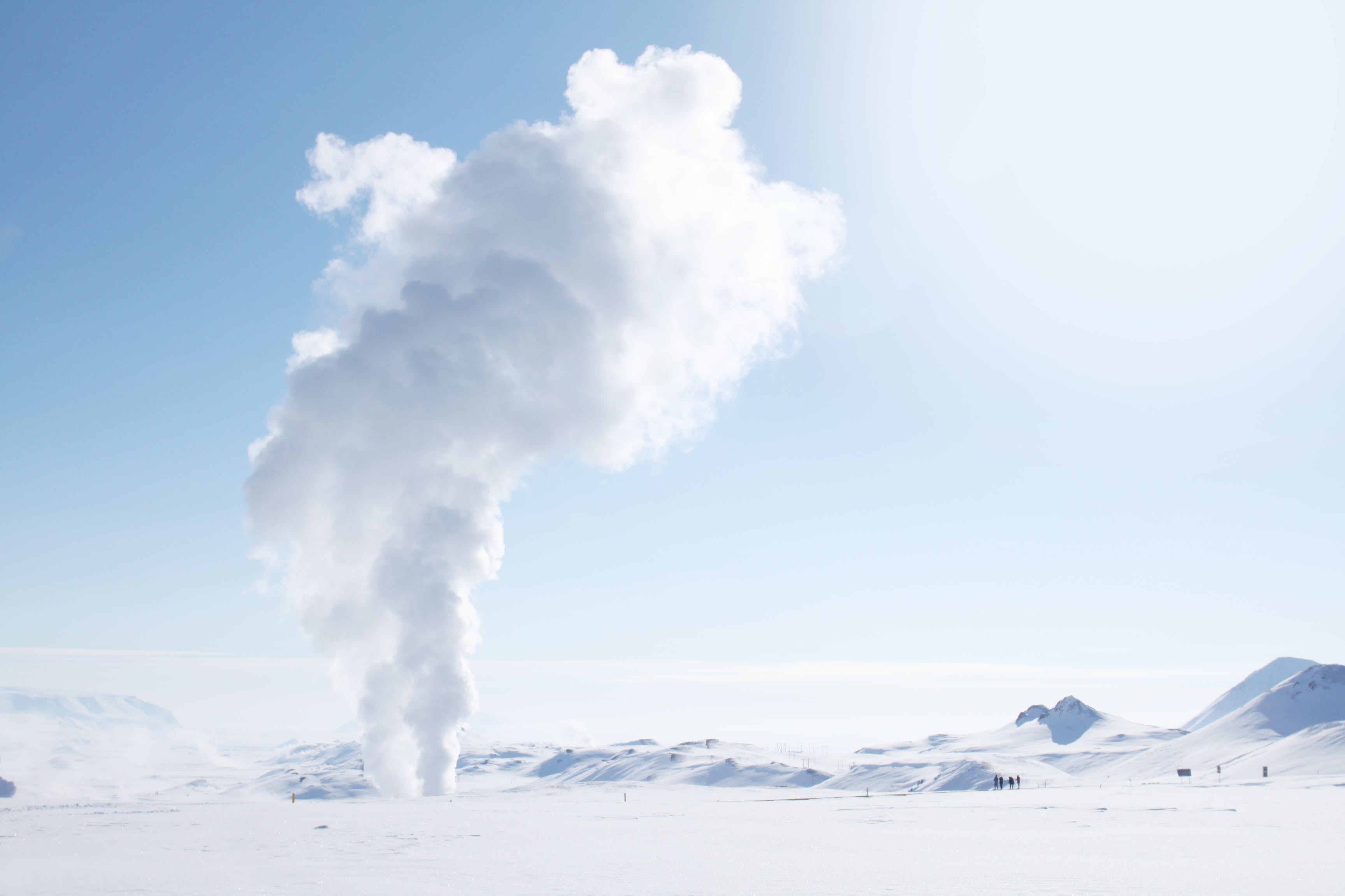 smoke rising from snow-covered field